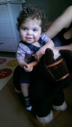 Loving his first ride on his rocking horse